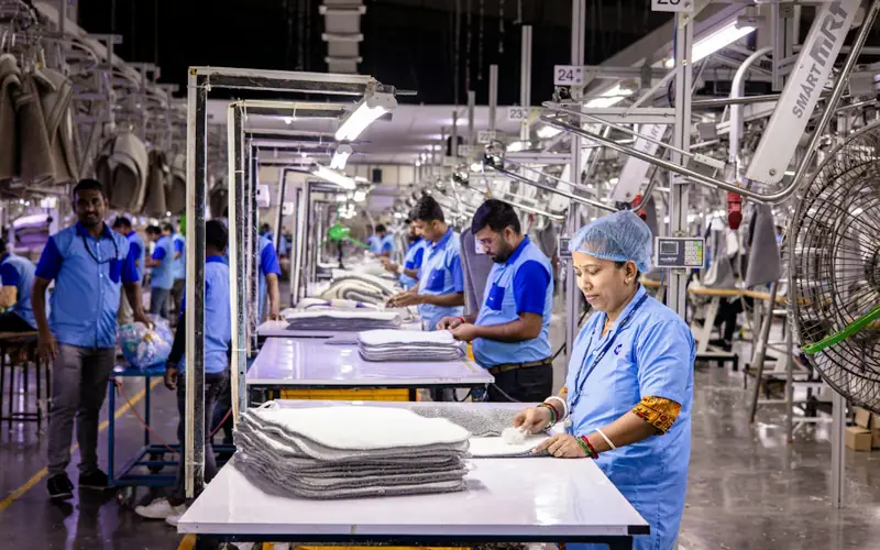 Workers at a production line inspecting finished goods